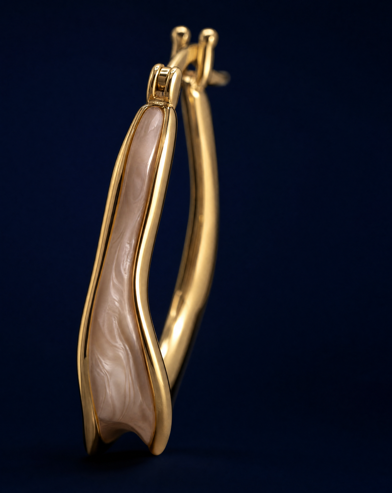 sculptural hoop earrings in gold-plated sterling silver with an elegant fluid silhouette and glossy enamel finish.