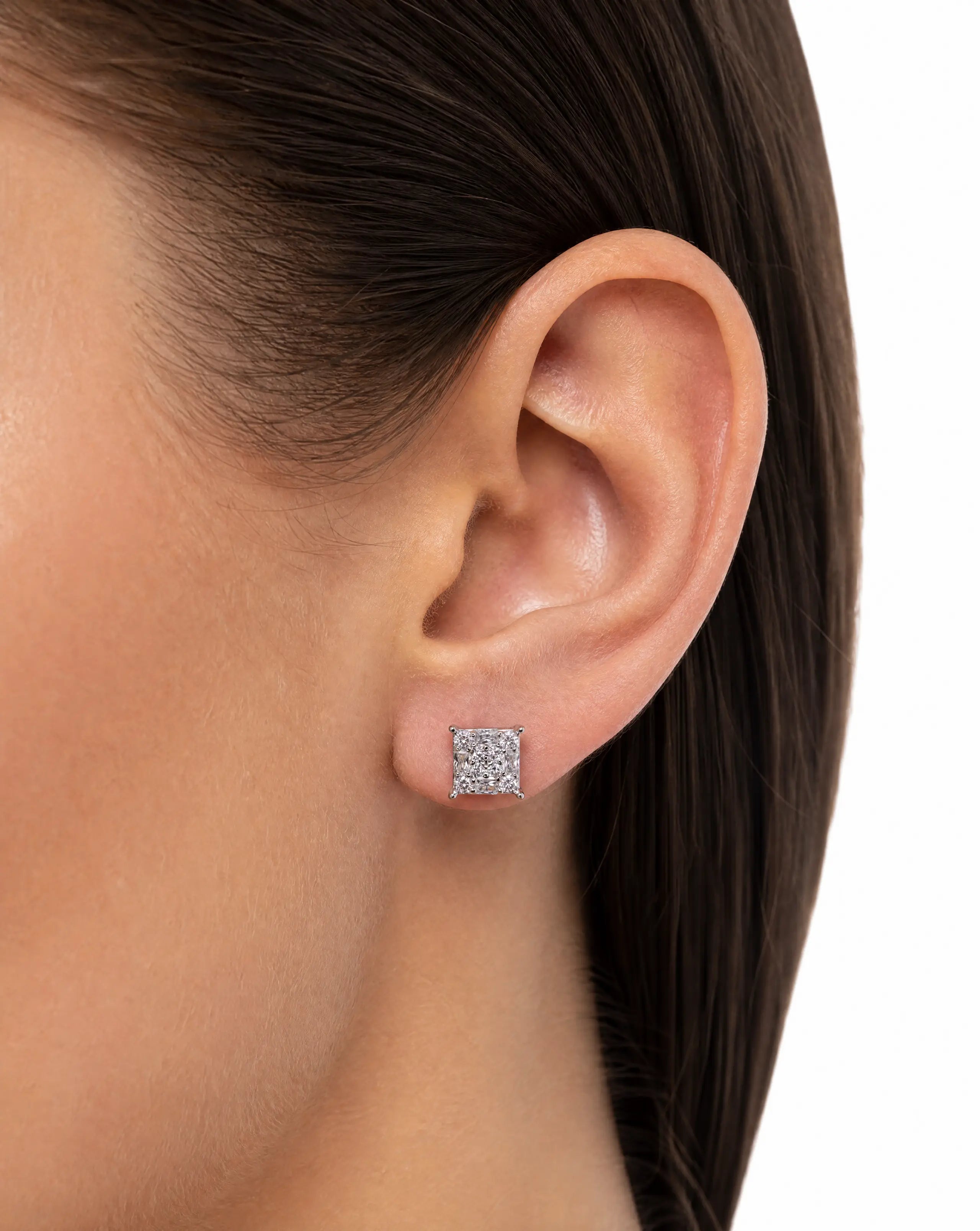 Close-up of an ear wearing a square diamond earring