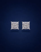 Pair of diamond stud earrings on a dark blue background