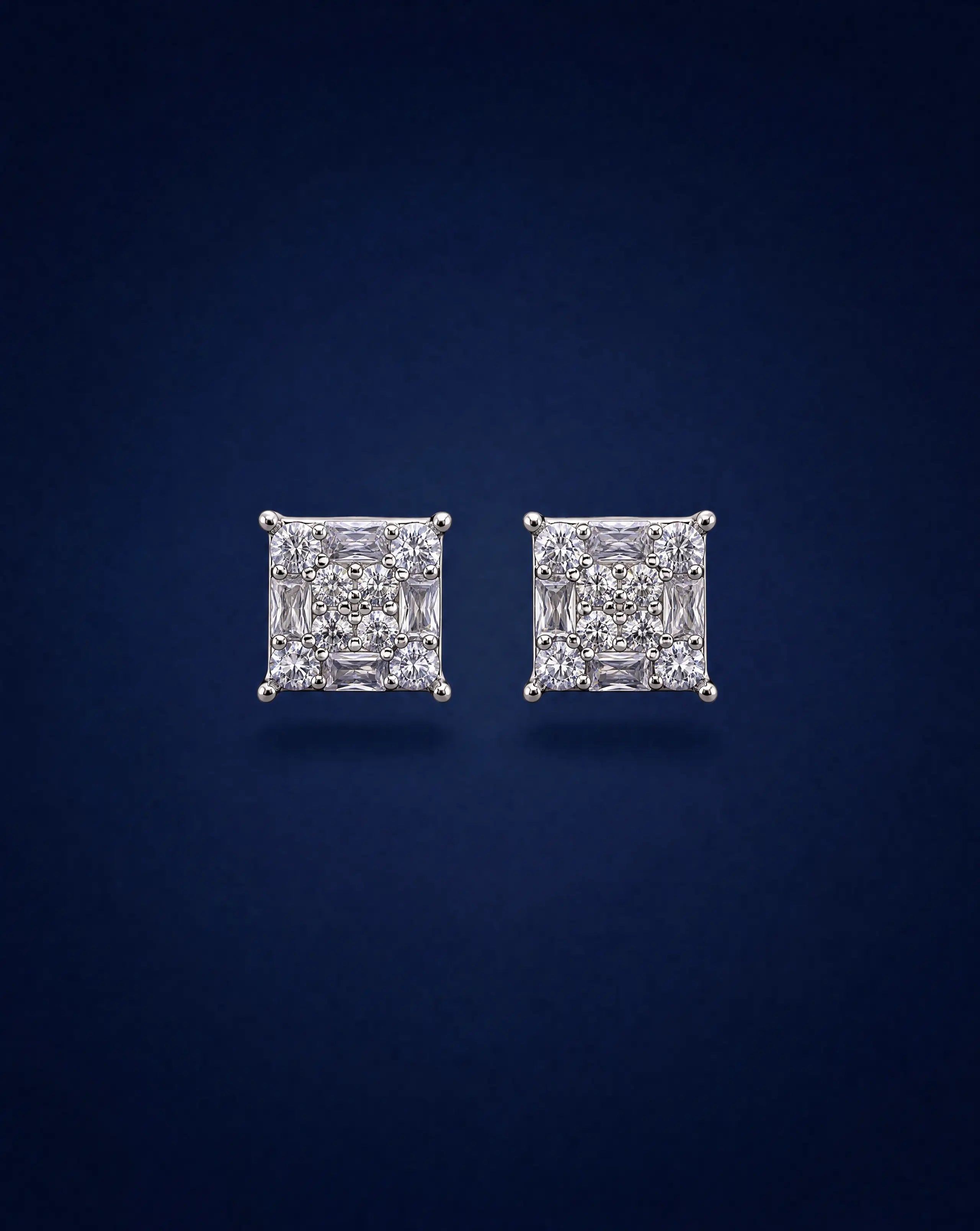 Pair of diamond stud earrings on a dark blue background