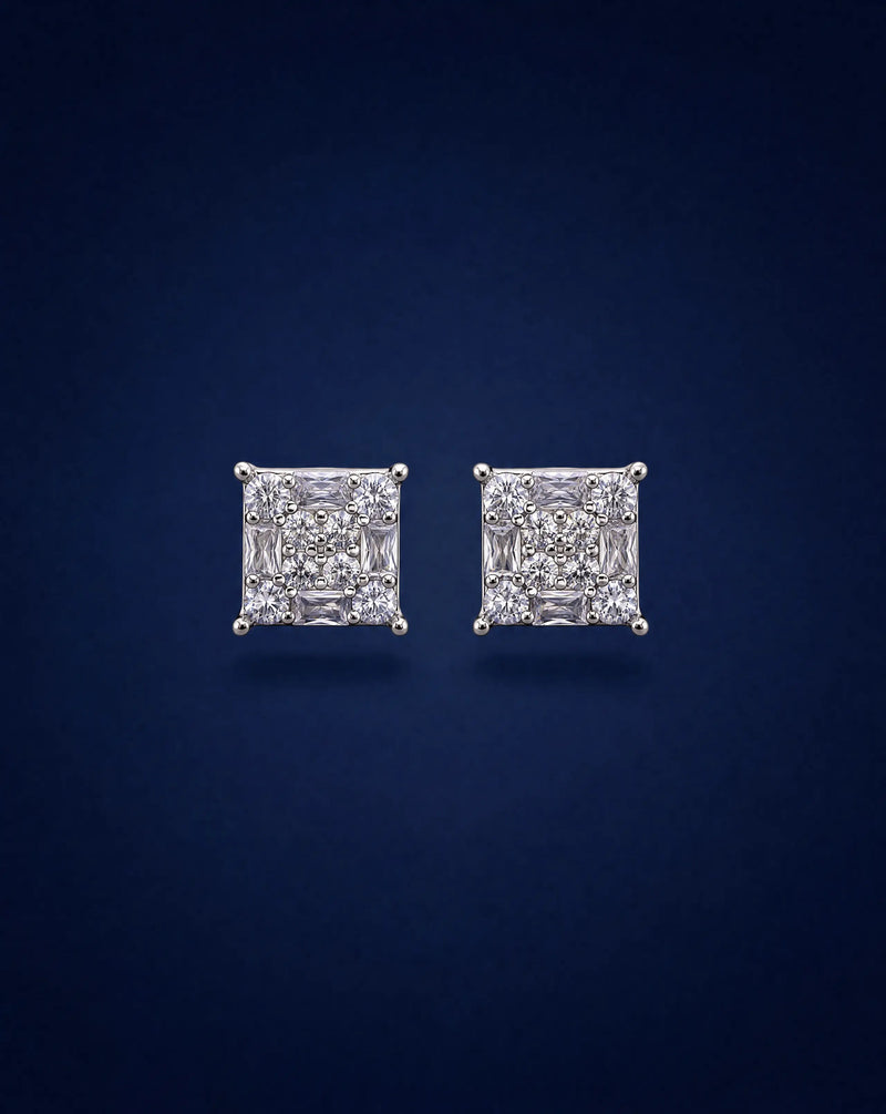 Pair of diamond stud earrings on a dark blue background