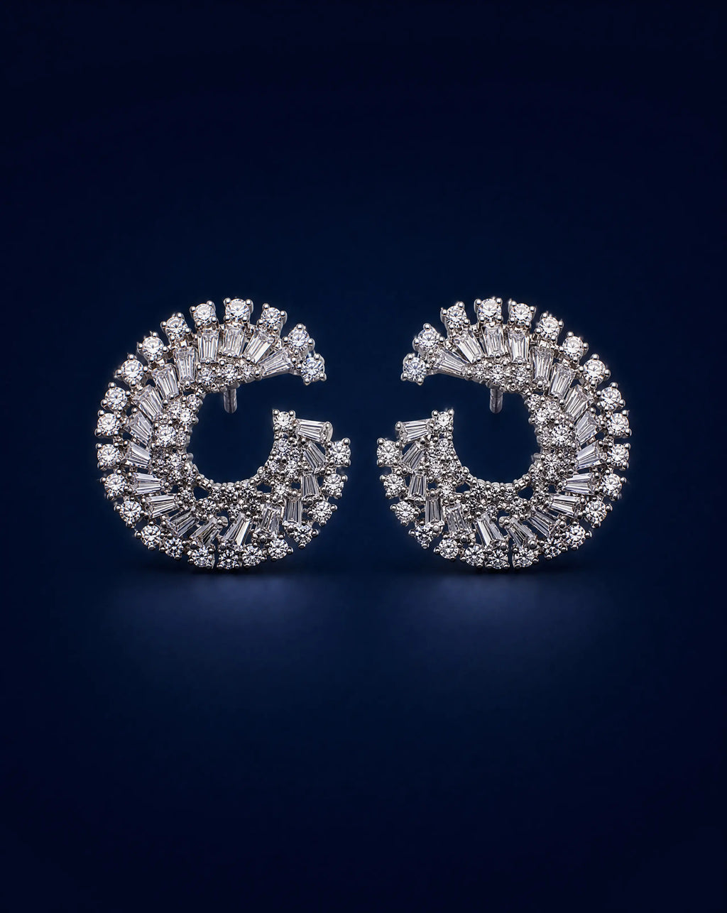 Pair of diamond earrings on a dark blue background