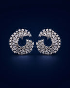 Pair of diamond earrings on a dark blue background