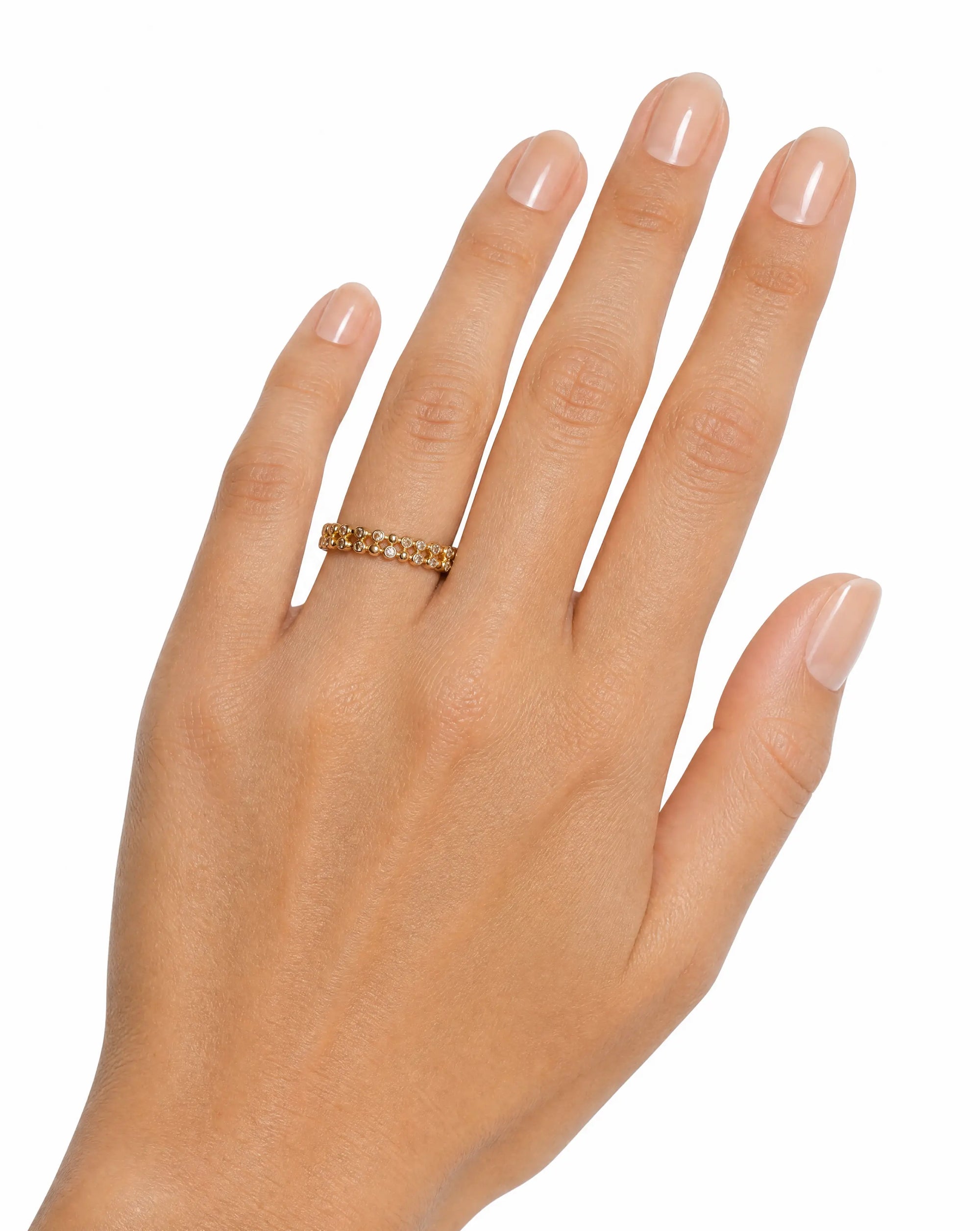 Hand wearing a gold ring on a white background