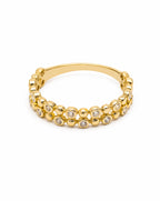 Gold bracelet with embedded stones on a white background