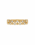 Gold ring with embedded diamonds on a white background