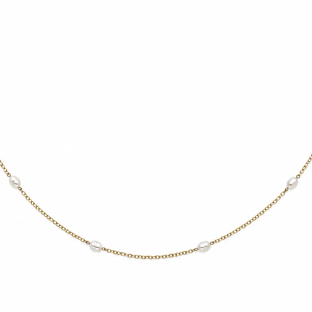 Gold necklace with small pearls on a white background