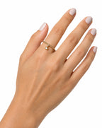Hand wearing a 14K gold ring with a small diamond