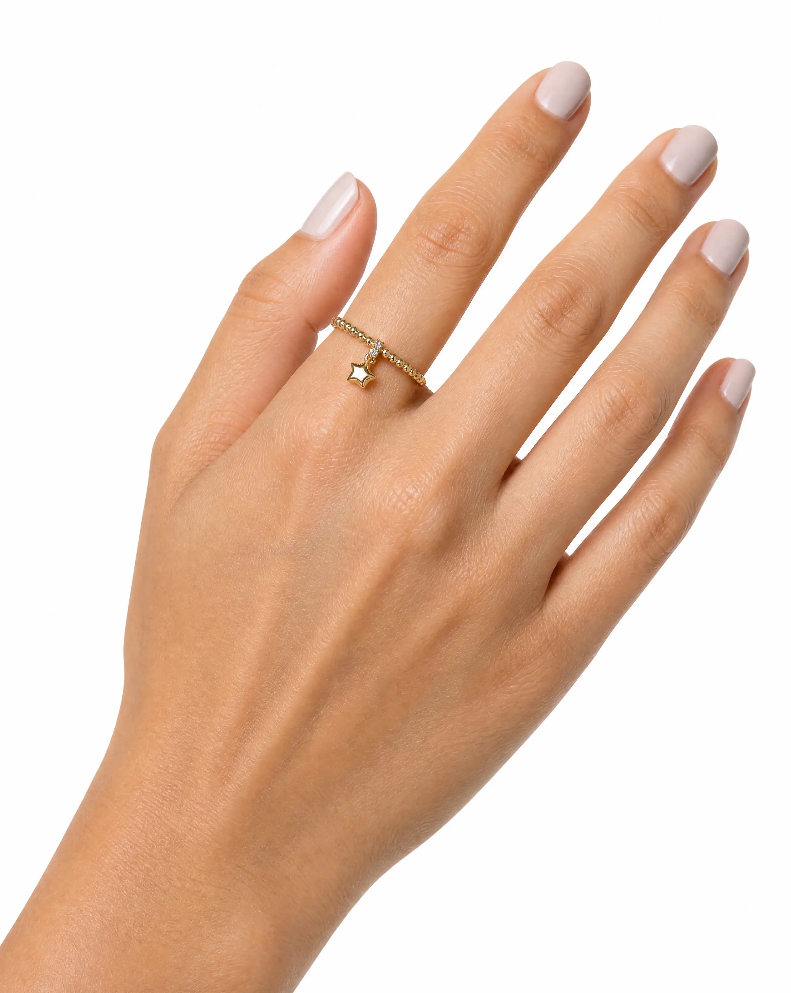 Hand wearing a 14K gold ring with a small diamond