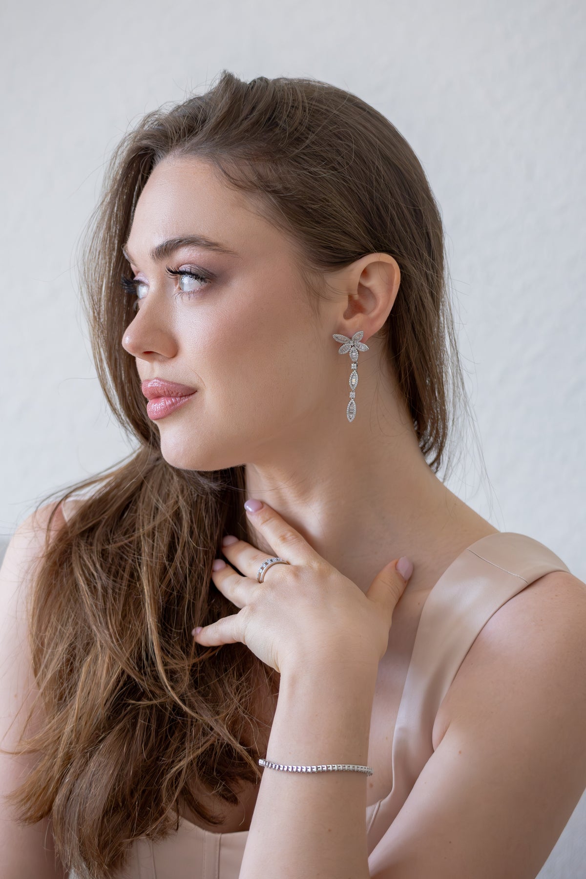 Woman wearing Delisa silver earrings and bracelet 